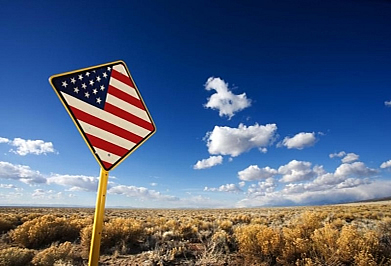 American flag on a road sign in the prairie
